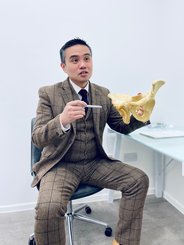 Doctor demonstrating hip anatomy on pelvic model